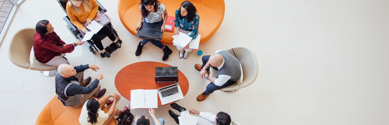 A top-down view of students sitting around a table
