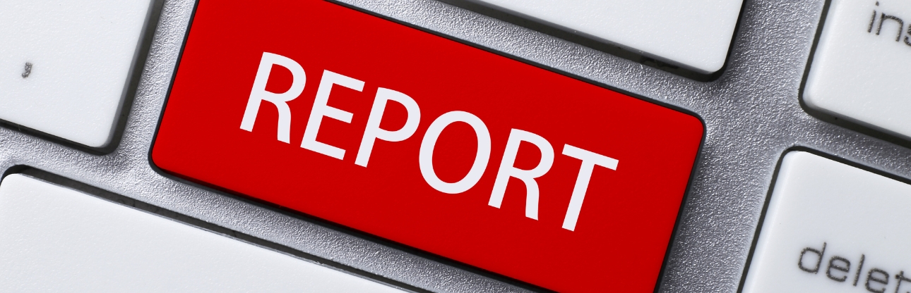 A red key on a keyboard readying report in white lettering