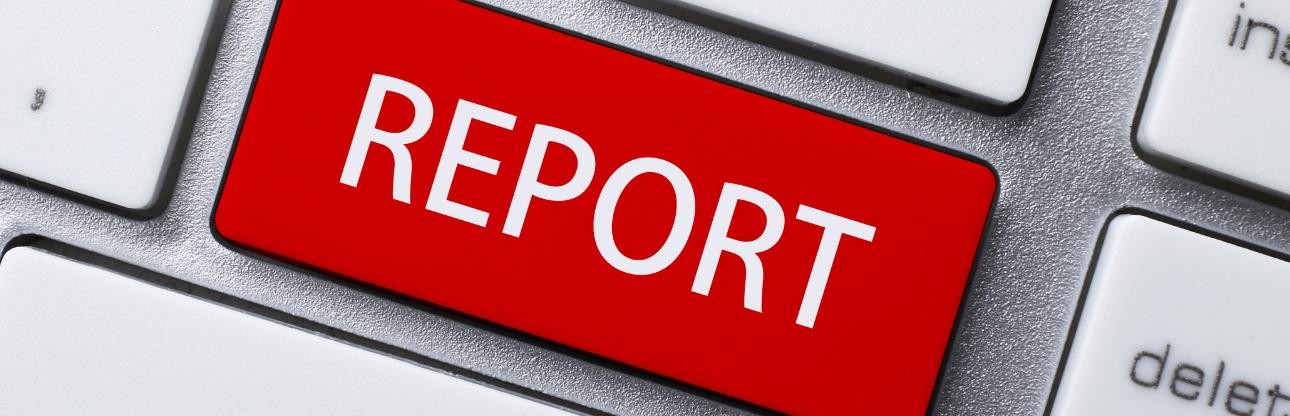 A red key on a keyboard readying report in white lettering