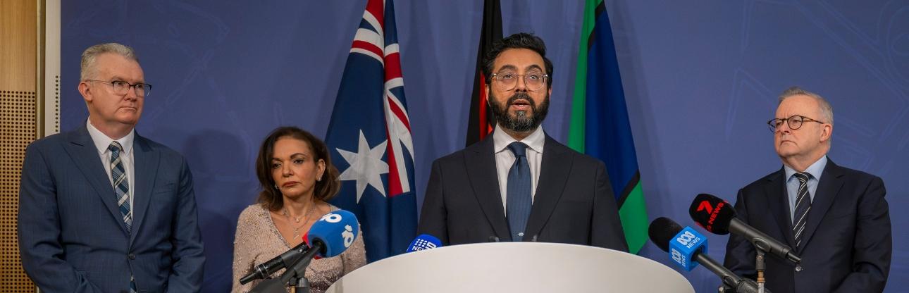 Banner image of the Islamophobia Envoy speaking at a lectern 